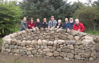 Group of volunteers at the sensory garden stone planters
