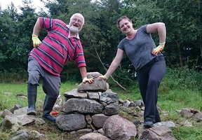 Two volunteers standing by the stone planters being build for the Balmedie Sensory garden